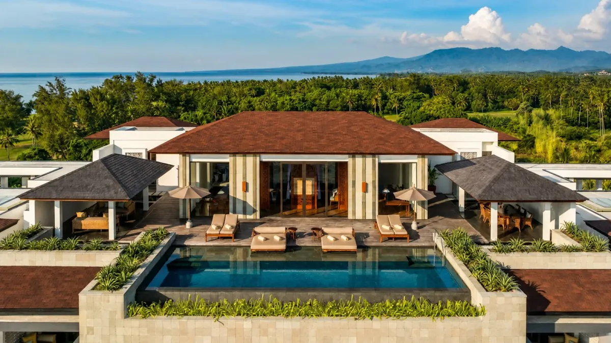 Aerial view of a private pool villa at The Sira Lombok, with the north-west coast and Lombok's mountains behind