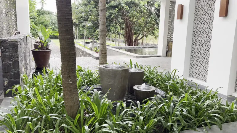 Stone fountains along the walkway to the lobby