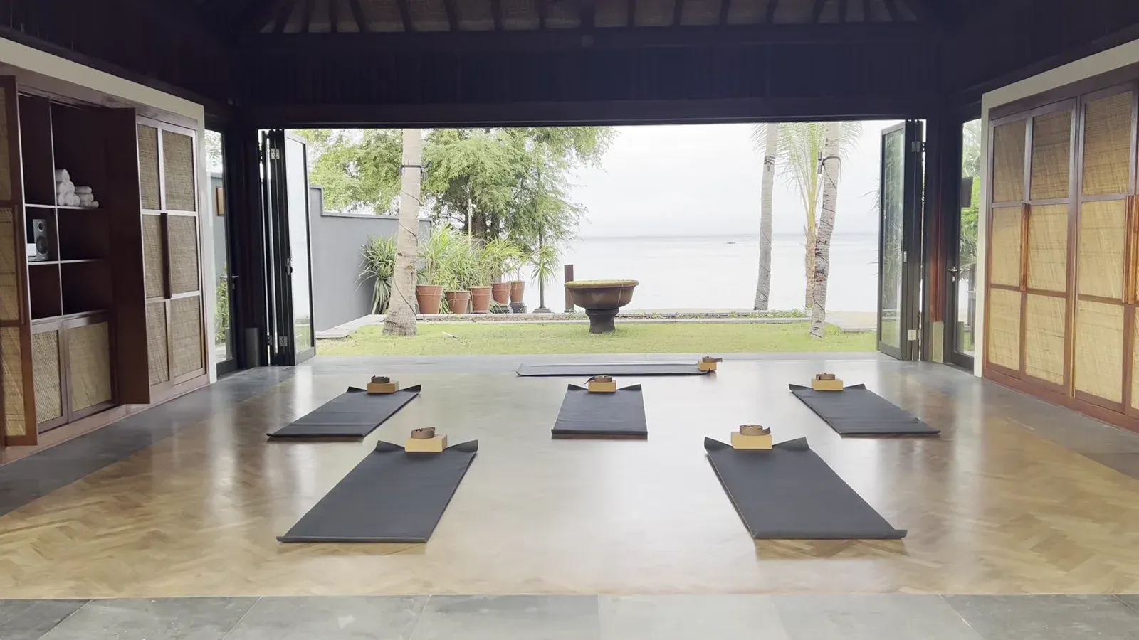 The open-sided yoga pavilion at The Sira Lombok, with mats laid out facing the sea
